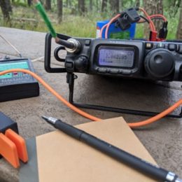 a small portable ham radio transceiver on a picnic table