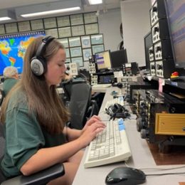 young ham radio operator at the controls in a station