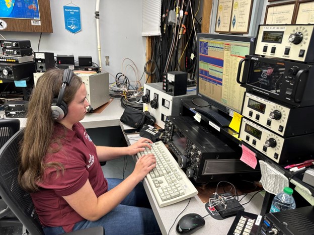 a young ham radio operator at station controls