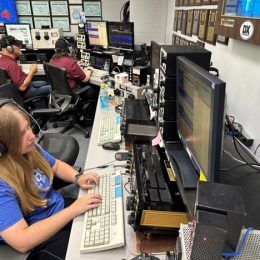 ham radio operators working at keyboards at large station