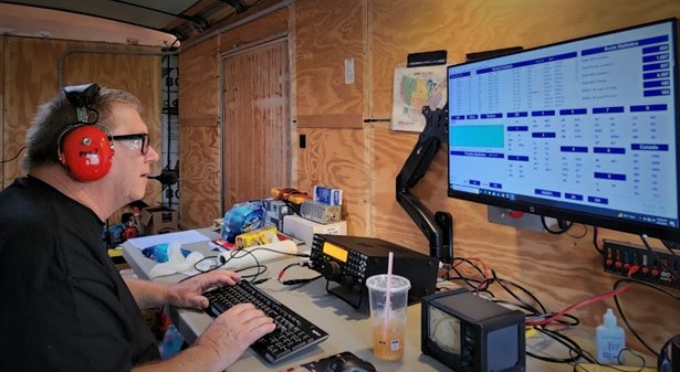 ham radio operator working in a portable trailer station