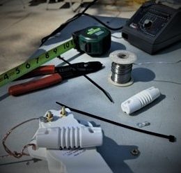 workbench with soldering iron & antenna parts crop