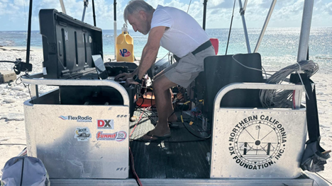 ham radio operator working on a portable station on beach