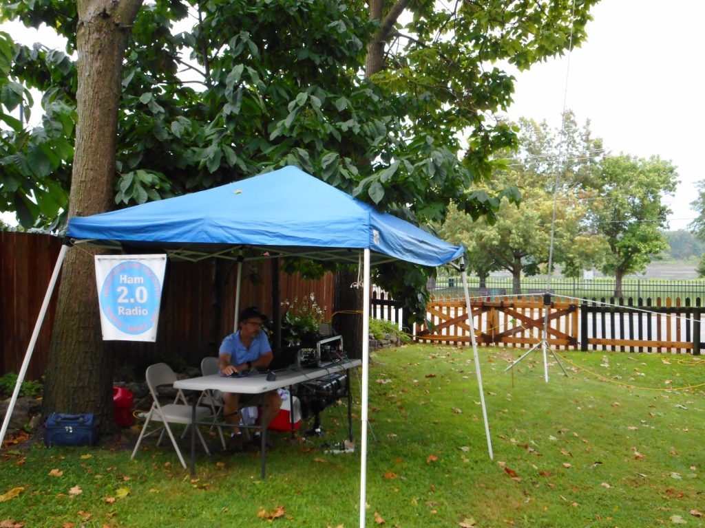 ham radio operator at a station under a tent