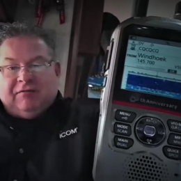 man holding handheld icom ham radio 2