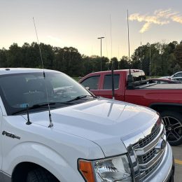 trucks parked with several mobile ham antennas installed