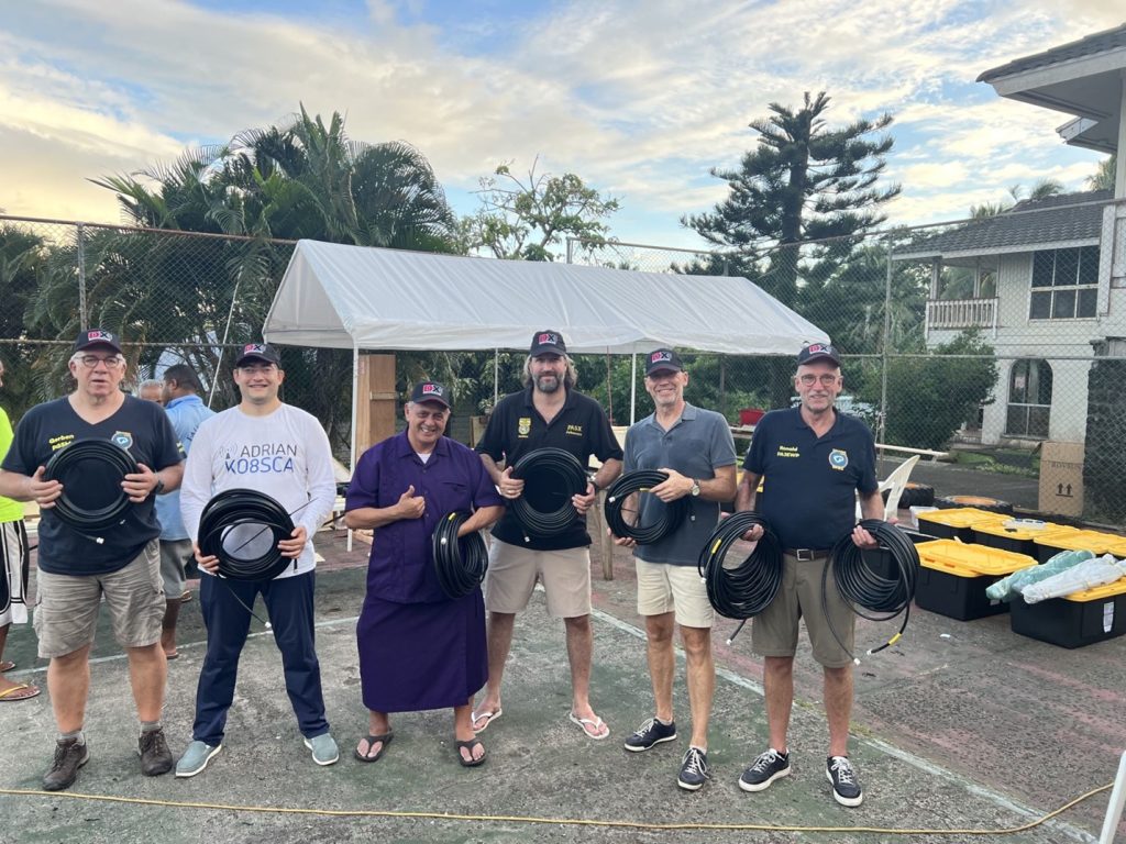 group of ham radio operators holding coax cable