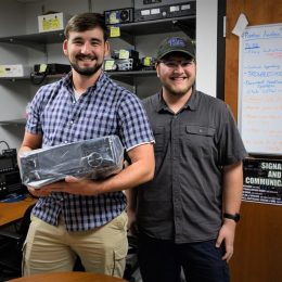 two young men with a new ham radio transceiver