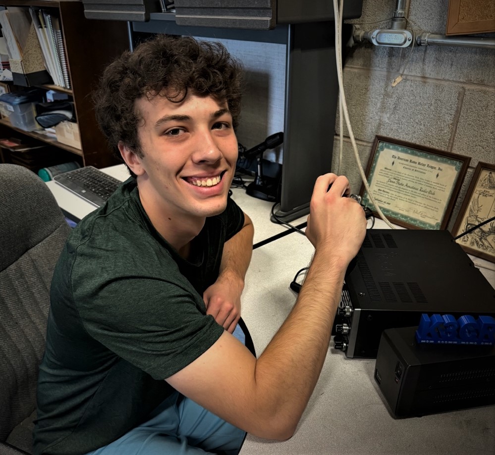 young man working at a ham radio station