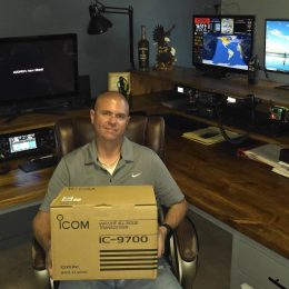 man holding a new ham radio in a box