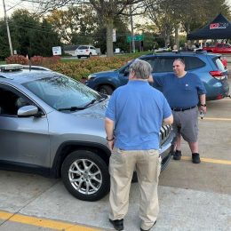 group meeting around an SUV with ham radio antennas