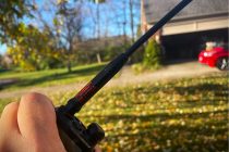 man holding a handheld ham radio with long antenna 3