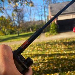 man holding a handheld ham radio with long antenna 3