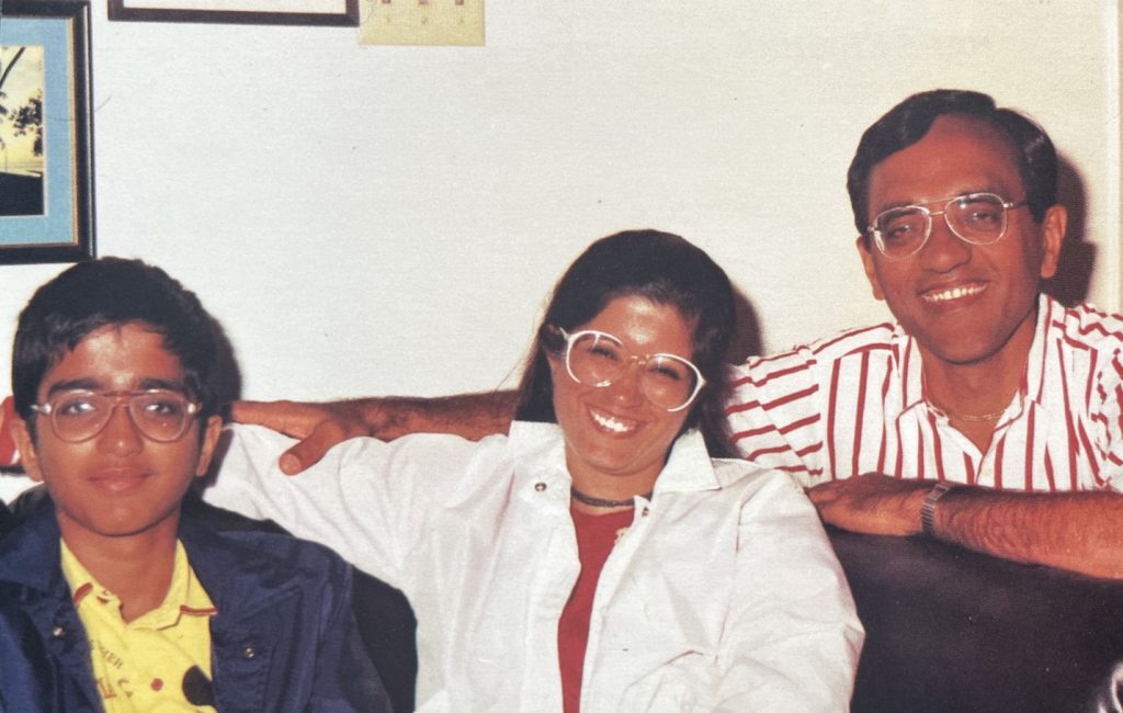 three smiling people in a vintage photograph