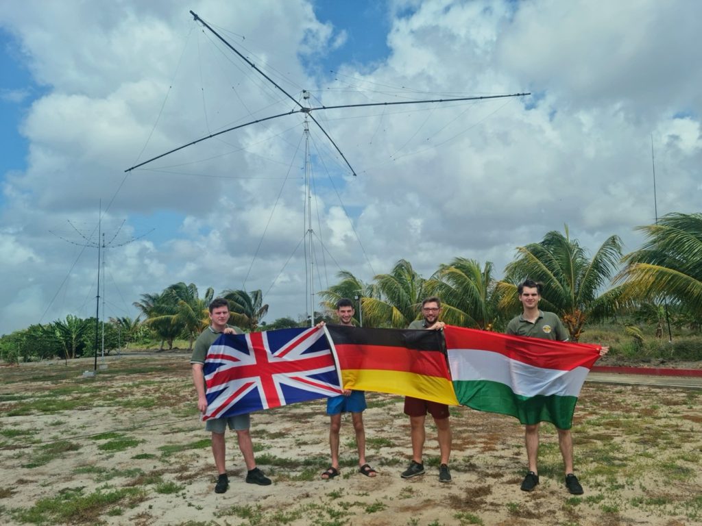 men holding flags near a large Antenna