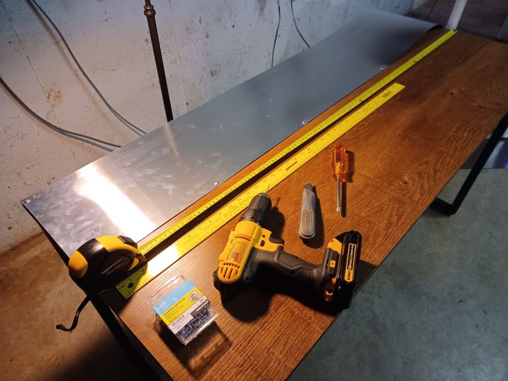 drill and tape measure resting on a work table