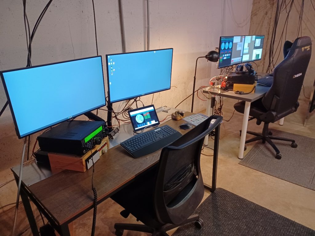 a pair of desks with radios & computer monitors