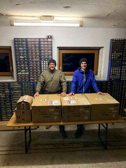 men standing near boxes on folding table