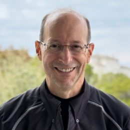 headshot of a man wearing glasses