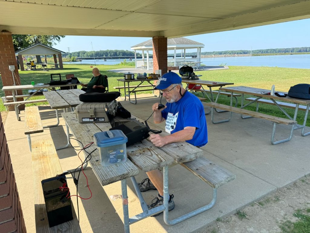 men working at a portable field day ham station